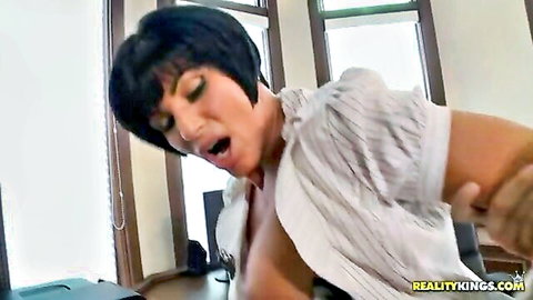 Short-haired brunette with big tits exposed in white blouse, mouth open in pleasure