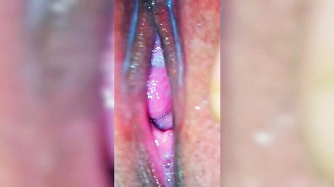 Extreme closeup of spread wet shaved pussy revealing pink inner labia and vagina
