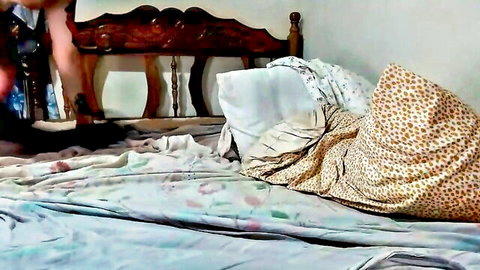 Sexy woman's legs in black stockings and high heels spread teasingly on messy bed