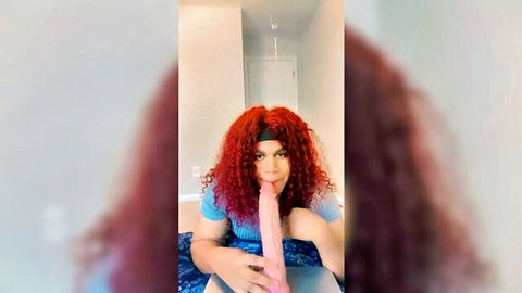 Curly redhead babe sucking large pink dildo solo