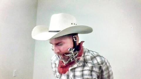 Bitgagged cowboy in metal harness and chains, BDSM fetish closeup