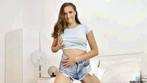 Stacy Cruz in light blue crop top and tiny denim shorts, seductive standing pose