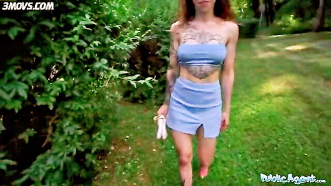 Tattooed redhead babe in blue crop top and mini skirt walks outdoors for public adventure
