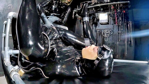 Bound latex-clad woman in BDSM restraint with mask, legs spread in fetish scene