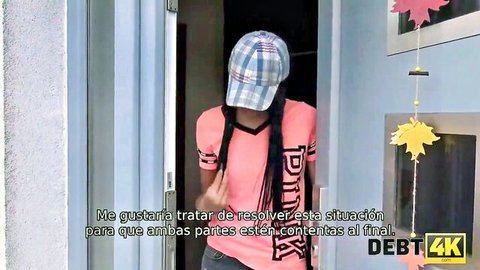 Ebony woman in pink top and cap at door, negotiating debt scenario