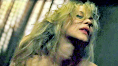 Sensual curly blonde woman with parted red lips looking up passionately
