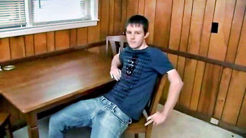 Young man in casual t-shirt and jeans sitting relaxed for 18th birthday video