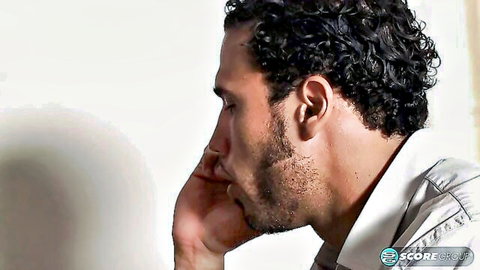 Curly-haired Latino man in profile, thoughtful pose, from 'Fuck The Boss' Wife' adult video
