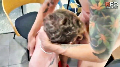 Tattooed man chokes curly-haired woman in chair in stepbrothers scene