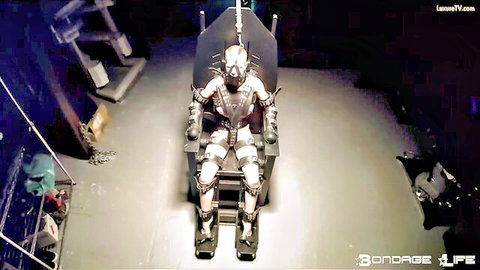 Greyhound bound in futuristic latex bondage suit and helmet