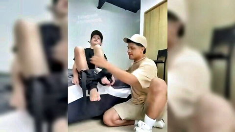 Two hot Asian guys playfully touching legs in intimate amateur scene