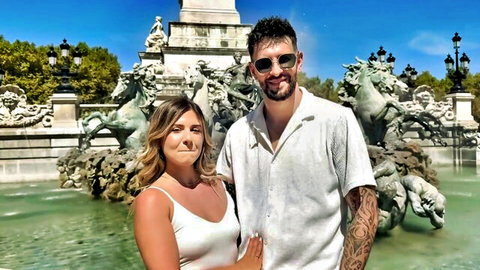 Ambre, 28yo Bordeaux nursing assistant, poses with tattooed partner at fountain