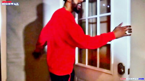 Black man in red sweater reaching for door in hot BBW interracial video