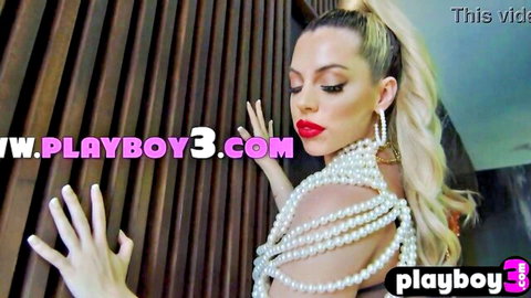 Seductive blonde in pearl necklace posing with curvy body, teasing undress