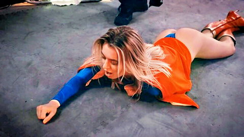 Blonde Supergirl cosplay lying defeated, exposed ass in thong and cape