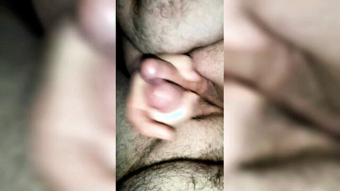 Close-up handjob on erect penis with semen splatter