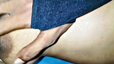 Indian woman in blue top with hand near lips, intimate Desi tease