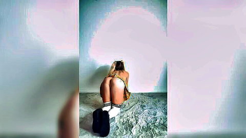 Blonde in short skirt bending over, exposing ass in solo tease