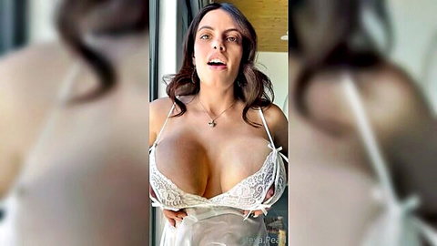 Brunette bombshell with massive tits in white lace lingerie tease