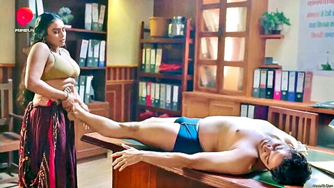 Desi woman in bra and skirt massages shirtless man's leg sensually