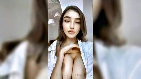 Sexy Olivia babe in open white shirt showing deep cleavage
