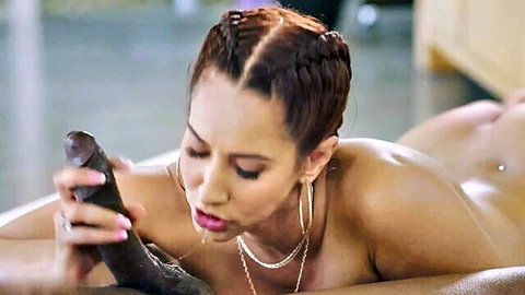Nude woman with red braids sucking large brown dildo solo