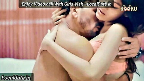 Indian couple in passionate embrace, woman in pink lingerie