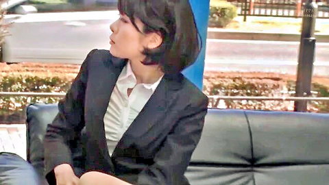 Japanese office woman in black suit sitting legs apart on public outdoor bench teasing thighs