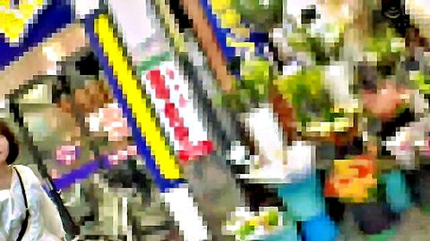 Blurry Asian market stall with fruits veggies and shopping women in public