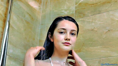Petite brunette teen with small tits in wet sheer lingerie poses seductively in shower