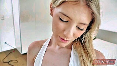 Blonde fit teen Melody Marks in low-cut white tank top, seductive gaze