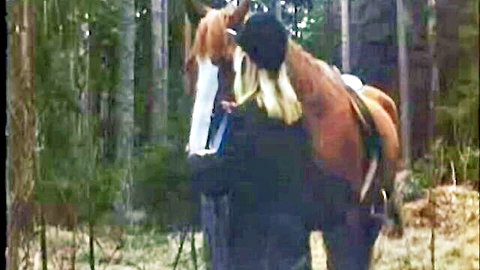 Anita Blonde hugs horse intimately in Swedish countryside forest, 1976 vintage