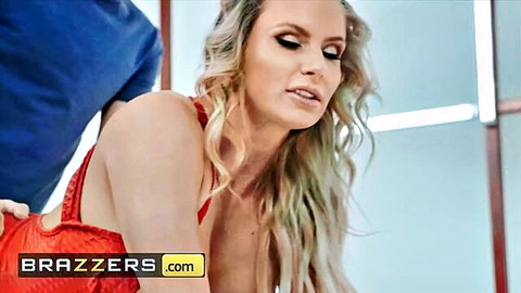 Blonde babe with huge fake tits exposes boobs in pulled-down red dress groped from behind