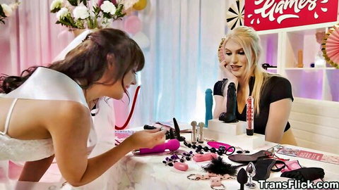 Izzy and Whitney posing with sex toys over table before Lauren
