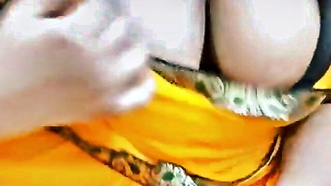 Tamil Sri Lankan girl in yellow saree teasing cleavage and curves