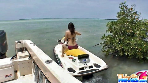 Sexy brunette in red bikini rides jet ski outdoors, POV tease before doggy style fuck
