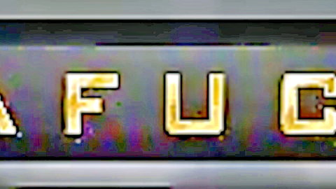 Glowing neon 'FUCK' sign in bold gold letters on dark background for adult porn vibe
