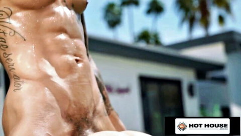 Muscular tattooed Caucasian hunk nude and wet by the pool