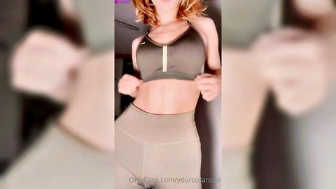 Cora Rossi in tight green sports bra and leggings, sexy changing pose