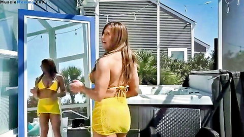 Two curvy models in skimpy yellow bikinis posing in summer try-on haul by pool