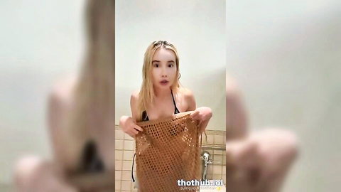 Lil Tay blonde lookalike in skimpy bikini teasing in bathroom mirror