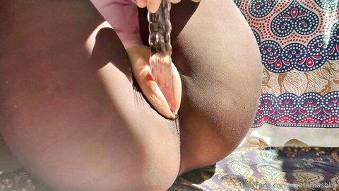 Ebony babe spreads ass and inserts clear glass dildo into wet shaved pussy