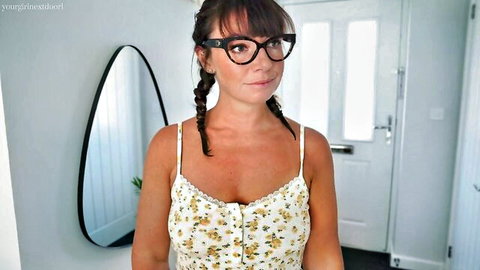 Busty MILF in glasses and pigtails teases deep cleavage in floral sundress by front door