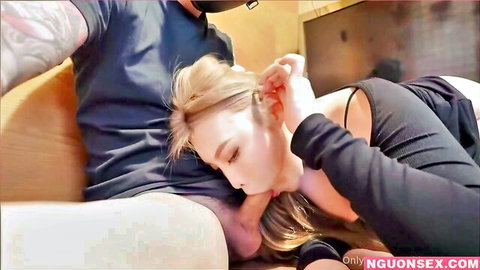 Blonde babe teasing blowjob on tattooed guy's clothed cock on couch amateur style