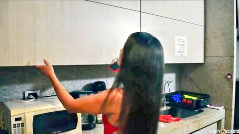 Hot Asian MILF in red tank top reaches up in kitchen, long black hair