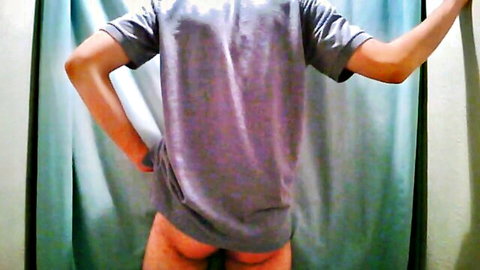 Slim guy in gray t-shirt showing bare round ass from behind, solo view