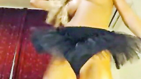 Topless blonde babe lifts black tutu skirt exposing shaved pussy and ass cheeks