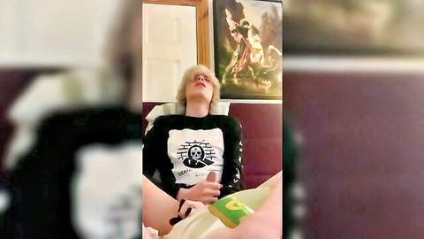 Blonde sissy in skull tee spreads legs with green dildo toy