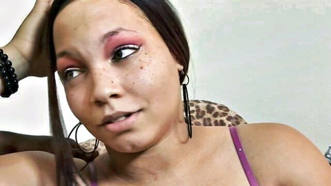 Sexy ebony babe with bold red eyeshadow, hoop earrings, and leopard top smirking seductively