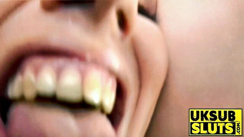Close-up of submissive UK MILF's open mouth and tongue in adult scene